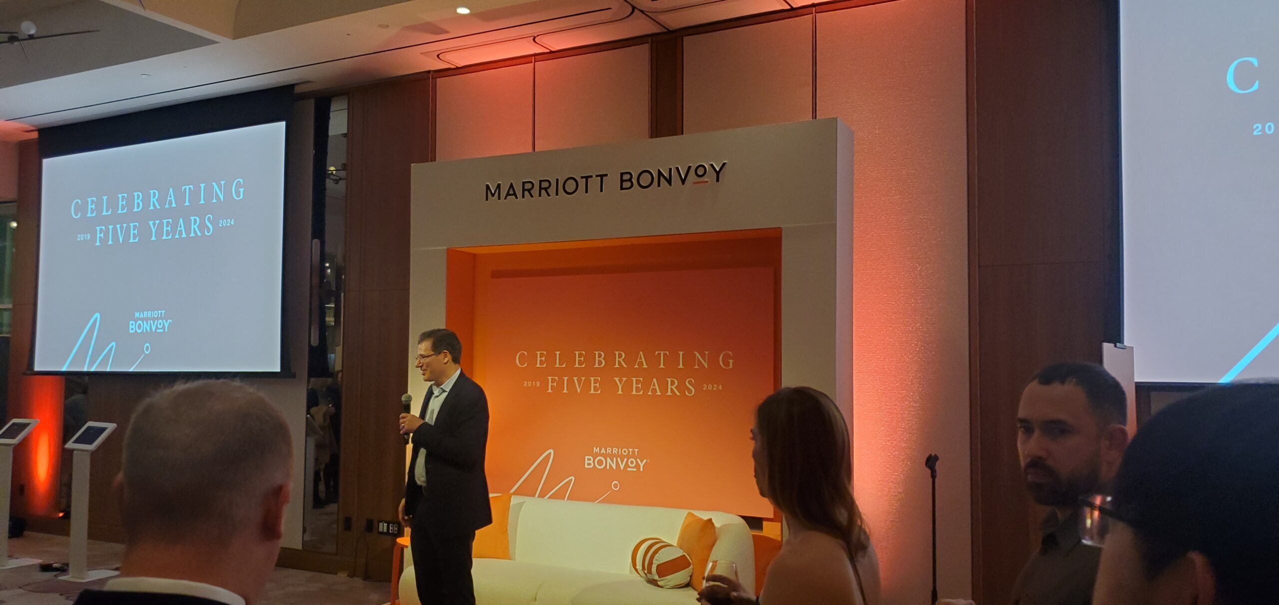Marriott executive delivering opening remarks on the 5th Anniversary stage