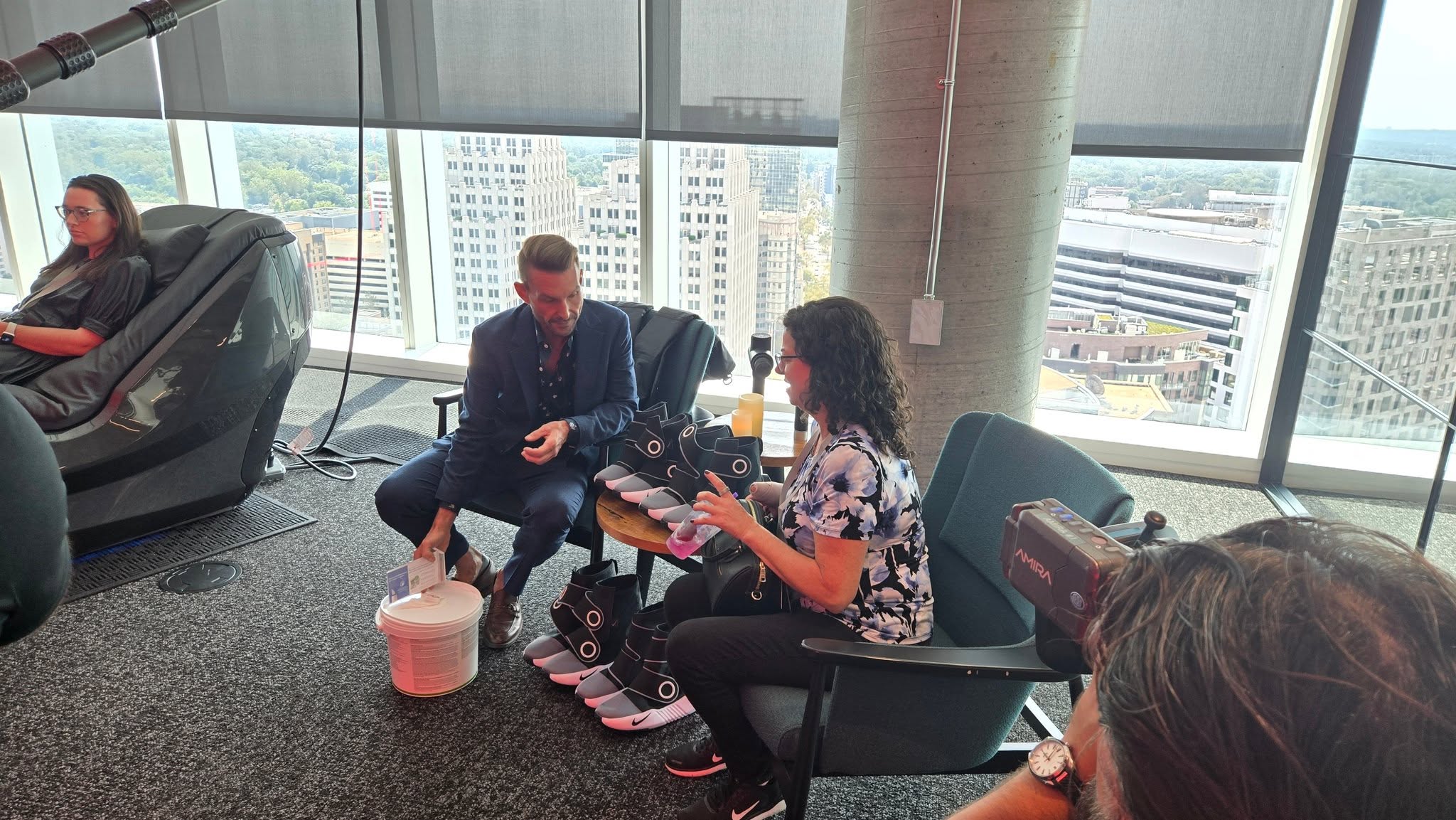 Maureen testing Normatec dynamic air compression recovery boots with Marriott wellness staff