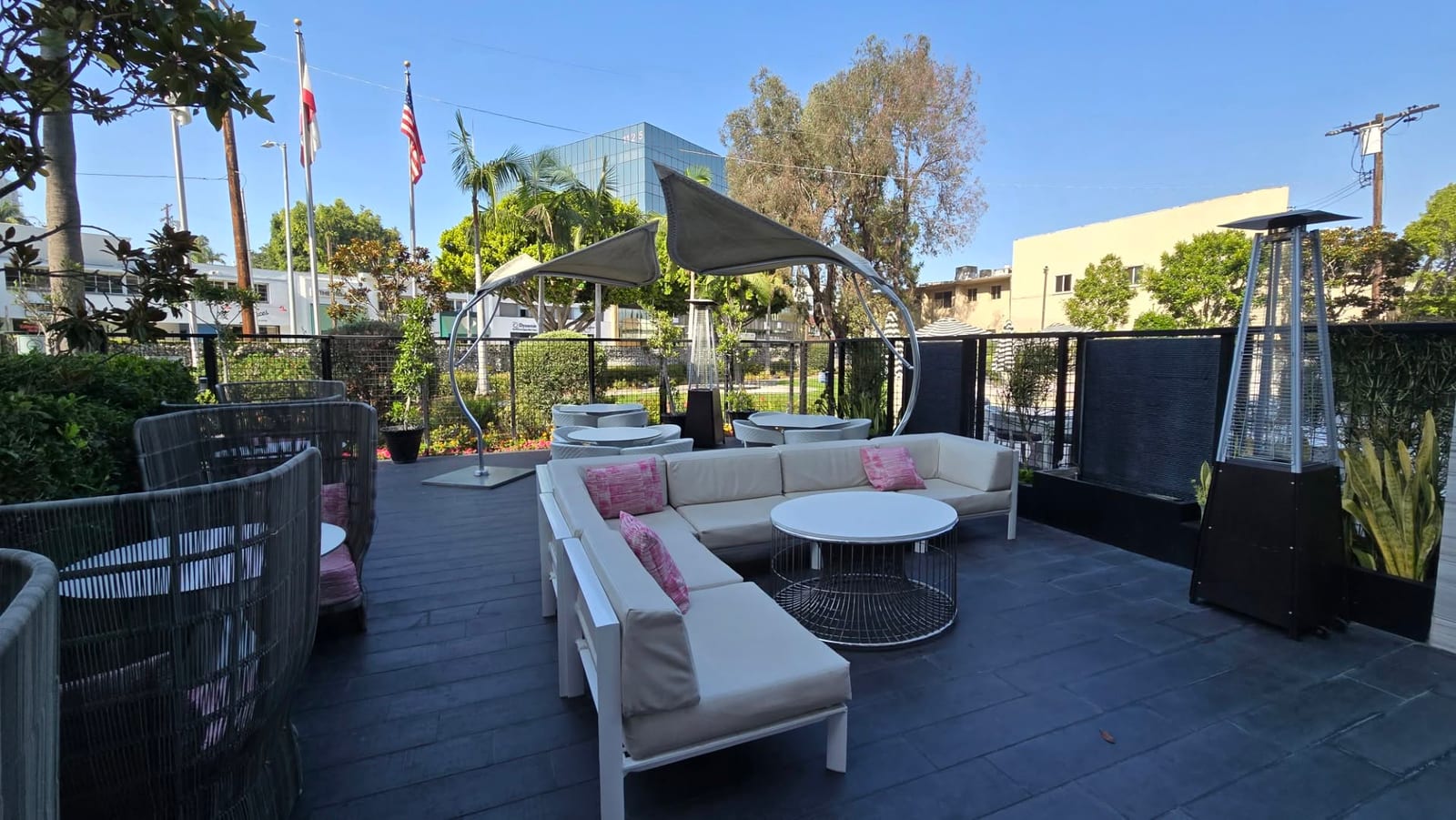 Outdoor patio lounge with curved sail canopy and sectional seating