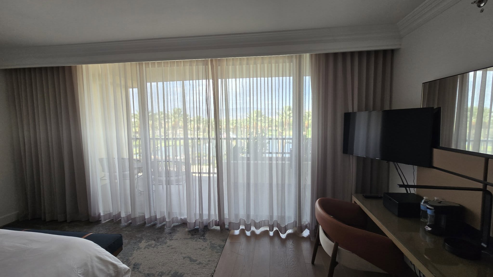 Initial King room view looking through sheer balcony curtains