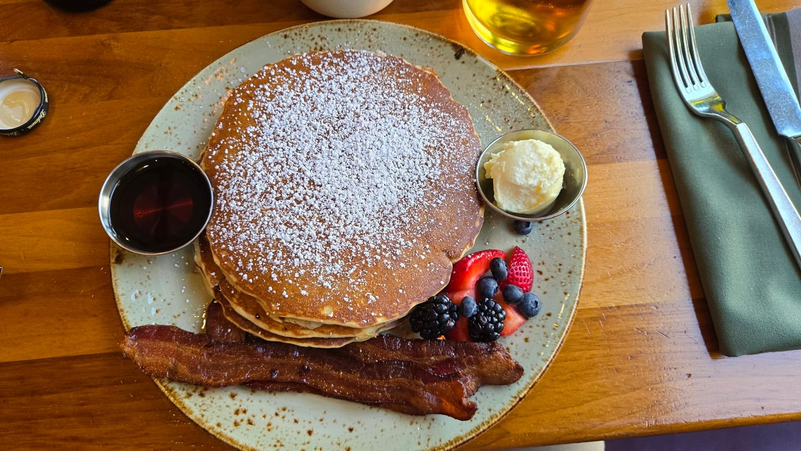 Golden buttermilk pancake breakfast with berries and crispy bacon