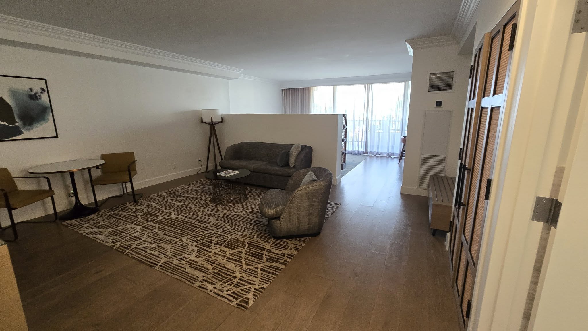Executive Suite 8126 living parlor with modern gray sofa and glass coffee table