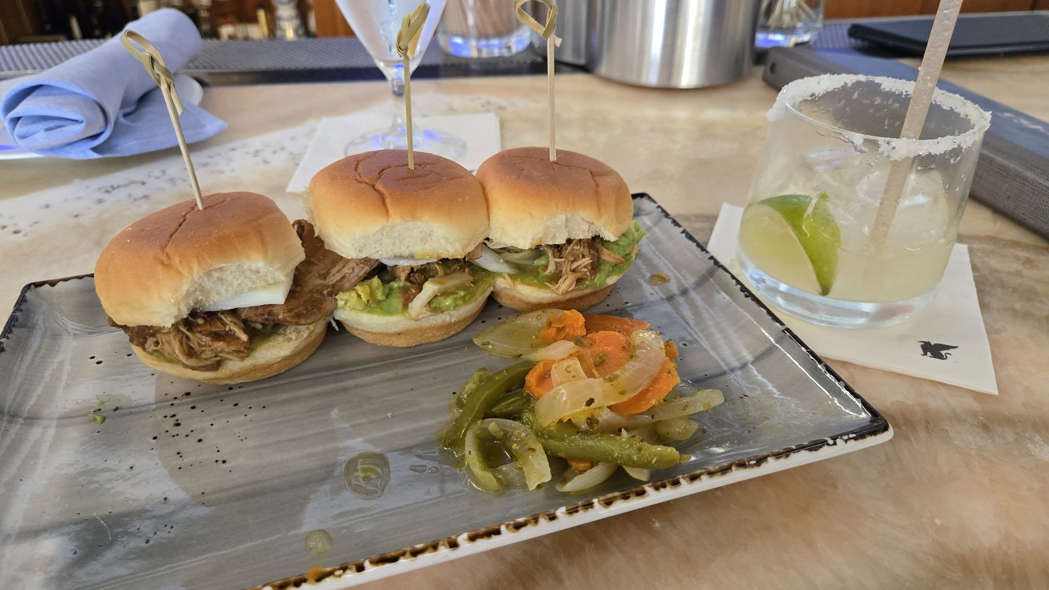 Savory pulled pork sliders topped with pickled vegetable escabeche