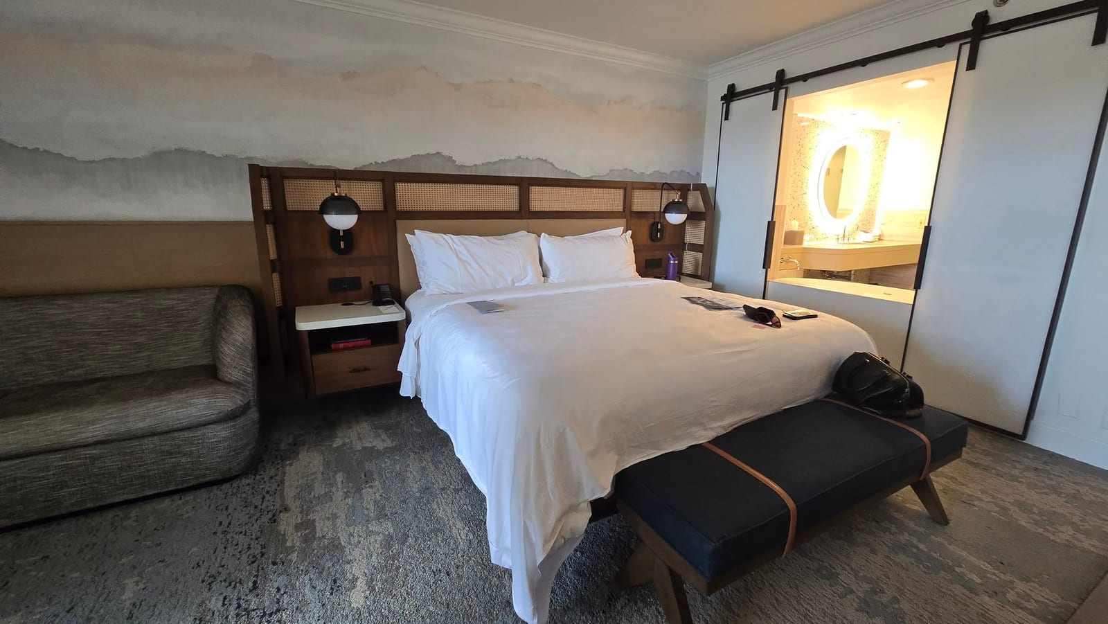 Master King bed with sliding barn doors open directly into the master bathroom