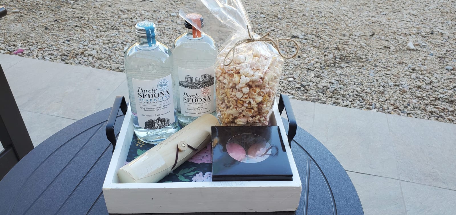 Ambassador Elite welcome amenity tray with Purely Sedona artesian waters, macarons, and scroll