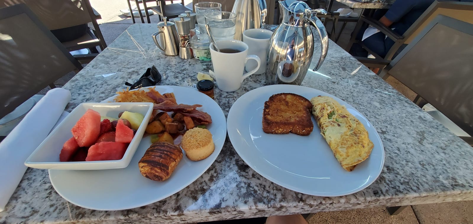 Scenic patio breakfast spread at Rita's with custom omelet, fresh fruit, and pastries