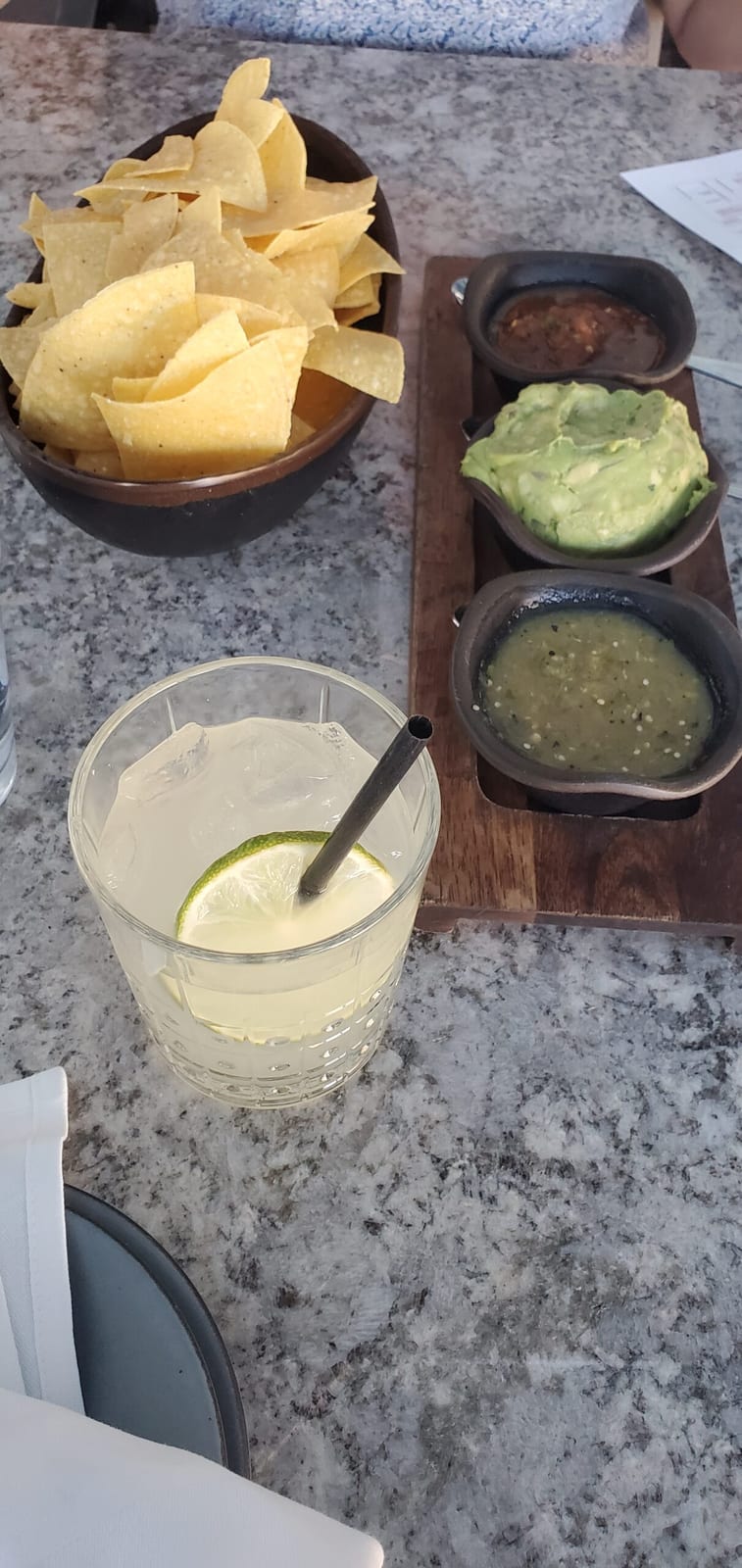 Rita's signature margarita on the rocks with tortilla chips and salsa trio