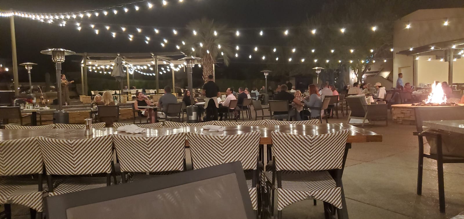 Live acoustic music and fire pit ambiance on Rita's patio
