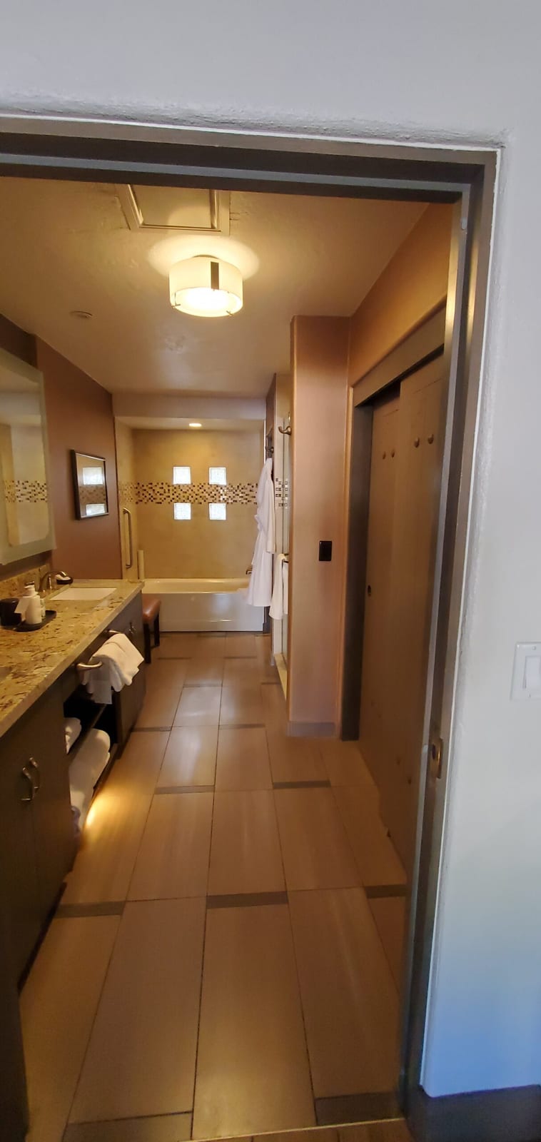 Perspective view from the bathroom vanity toward the deep soaking tub