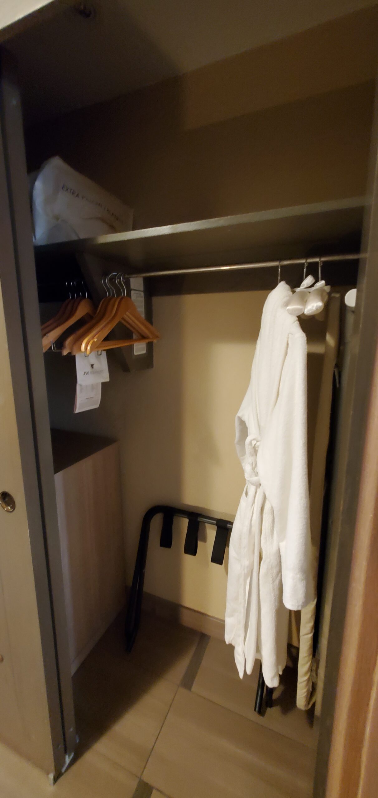 Walk-in dressing closet with waffle bathrobe and luggage storage