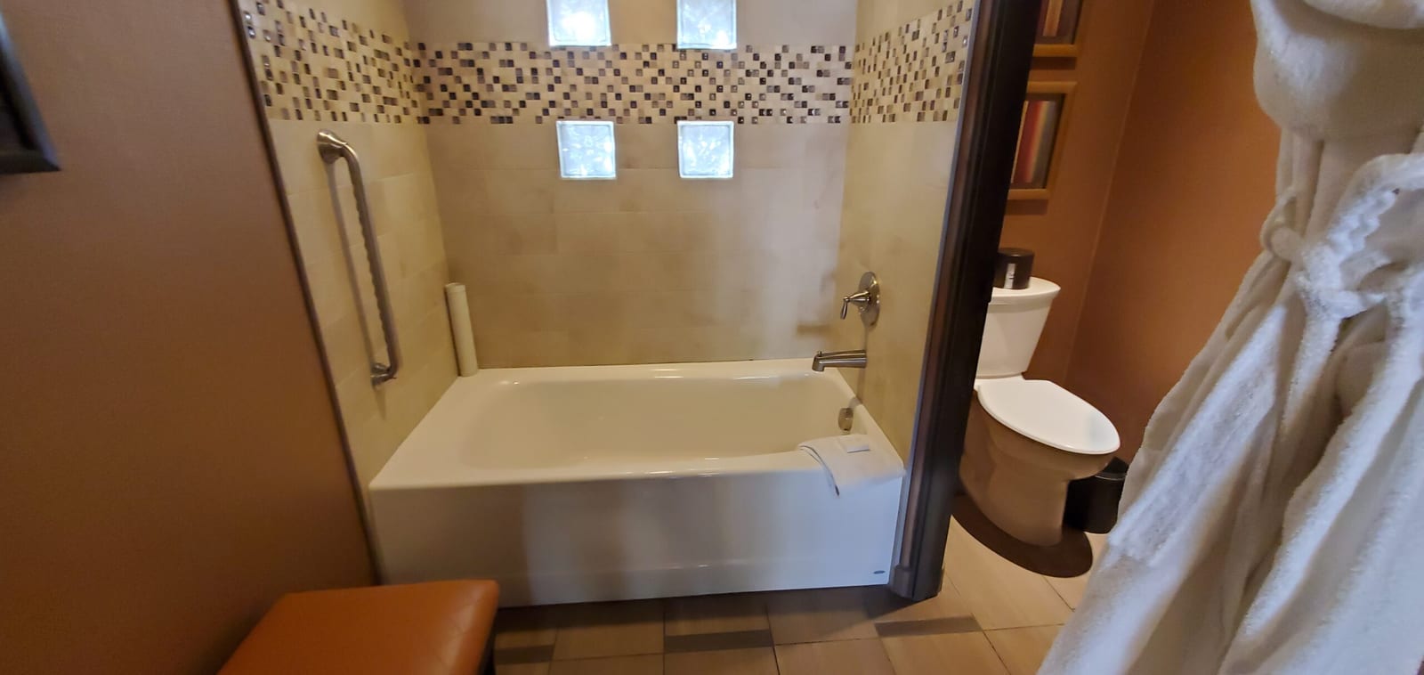 Deep soaking tub beneath daylight glass blocks