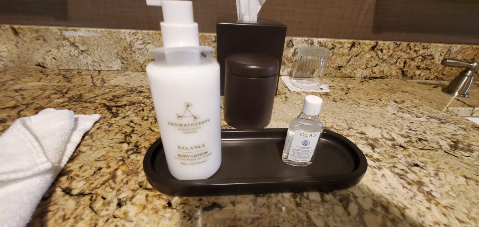 Vanity counter amenities tray with body lotion and OLAS mouthwash