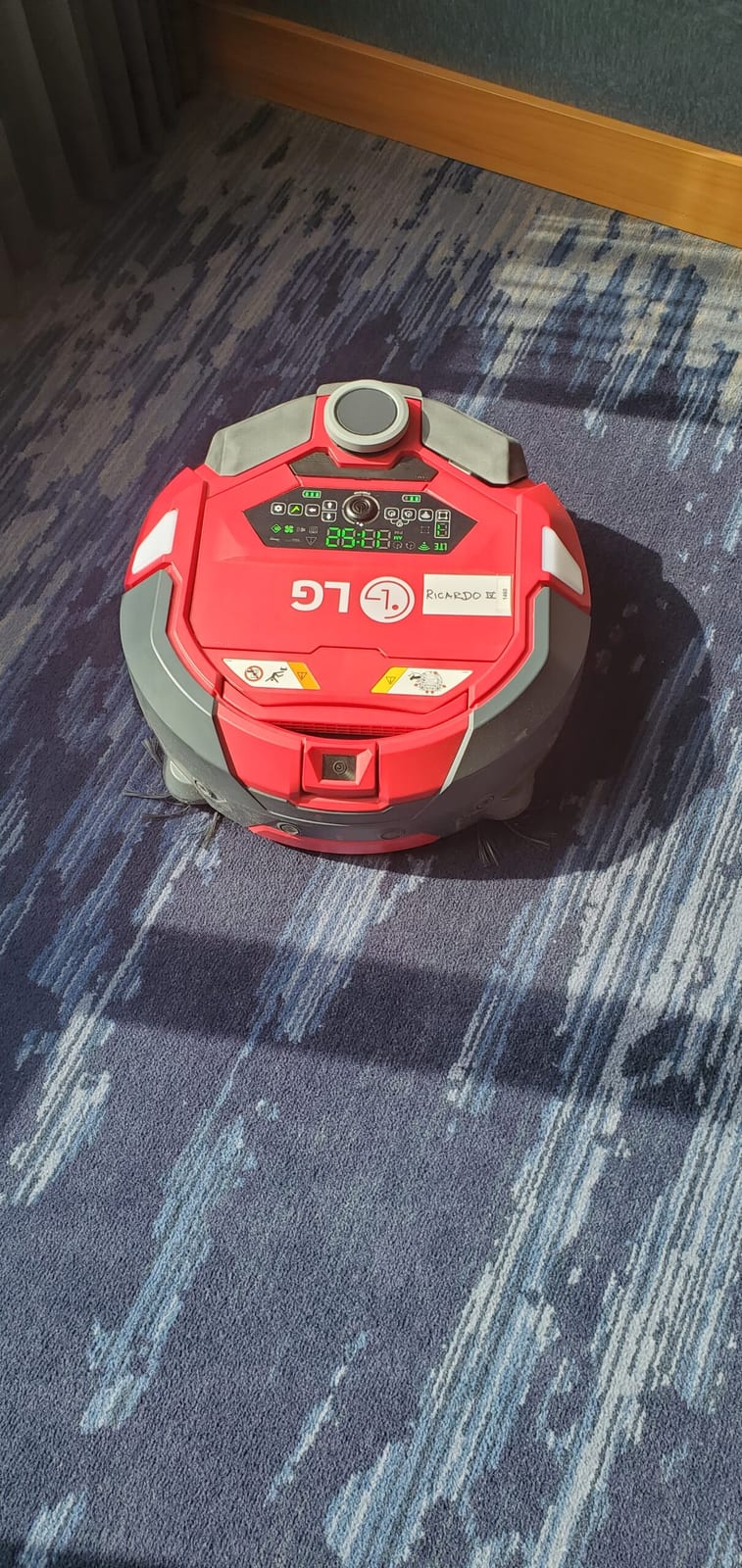 Autonomous LG hallway robot vacuum RICARDO IV on the guest room floors
