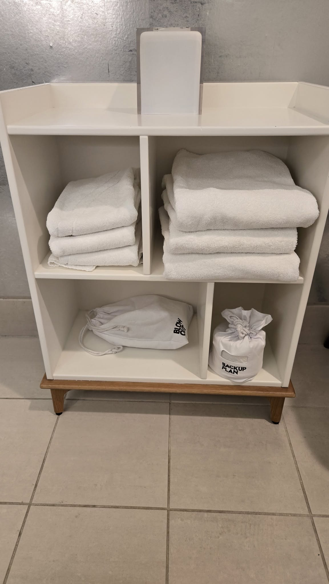 Linen ladder stand with BLOW OUT hair dryer and BACKUP PLAN pouches