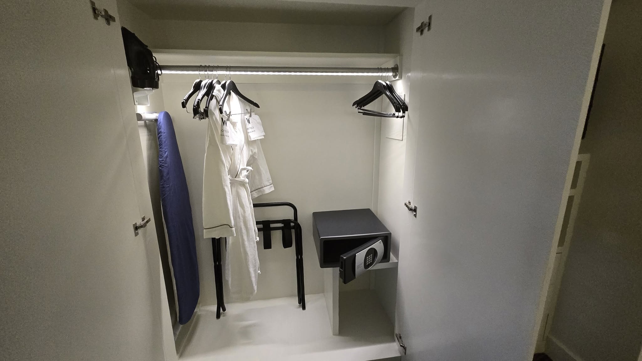 Wardrobe interior with signature W bathrobes and valet bags